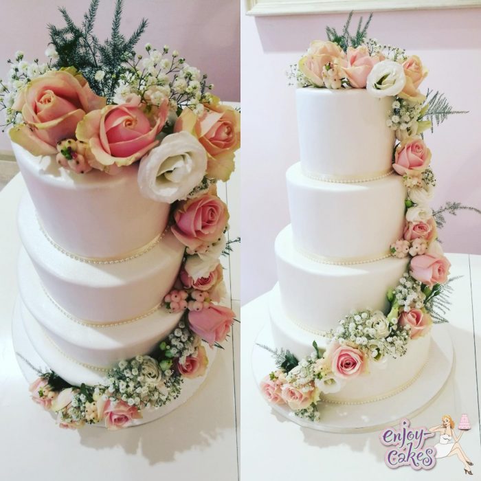 White wedding cake with real flowers