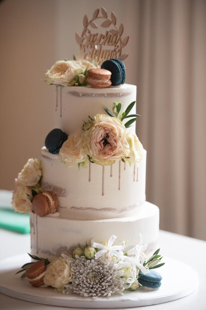 Semi naked cake with macarons and flowers