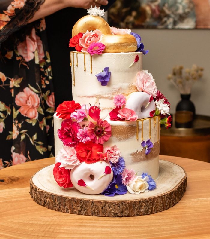 Semi naked cake with donuts and edible flowers