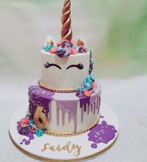 Unicorn cake with purple dripp