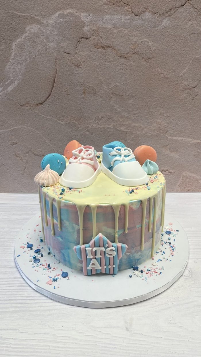 Gender reveal baby shoes cake